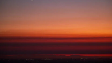 Short Timelapse of Moonset at Sunset Stock Footage 283712595