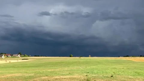 Short video of dusty path over the autumn field and village before storm under Stock Footage 287257649