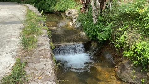 Short waterfall on small river due to height difference Stock Footage 295493044