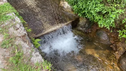 Short waterfall on small river due to height difference Stock Footage 295493167