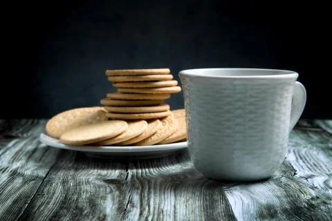Shortbread and a cup of tea on a rustic table Stock Photos