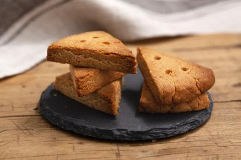 Shortbread biscuit on black stone plate on wood table, closedup Stock Photos