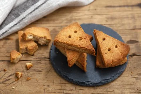 Shortbread biscuit on round black stone plate on wood table Stock Photos