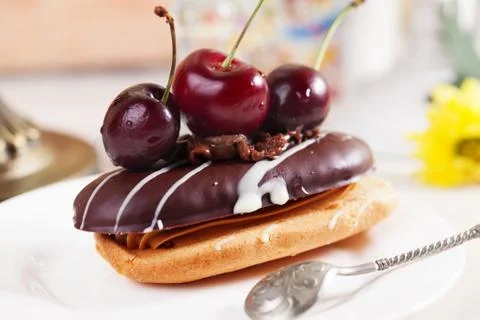 Shortbread cake with chocolate eclair a cherry Stock Photos