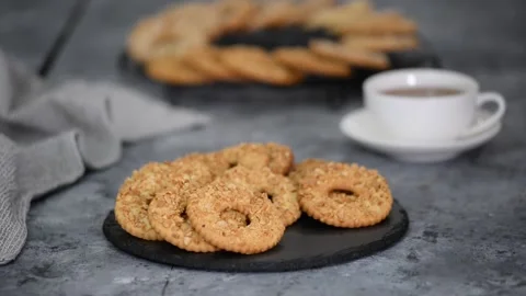 Shortbread cookie ring with peanuts and cup of tea on wooden table. Stock Footage 150327854