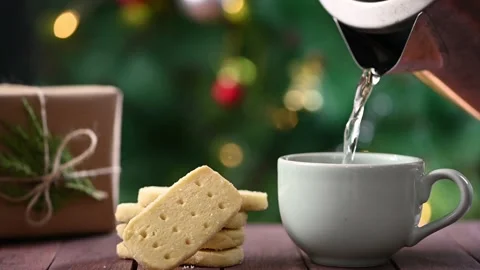 Shortbread cookies, coffee and wrapped Christmas gift on table Stock Footage 145229699