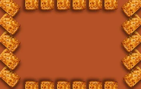 Shortbread frame with shadow on brown background. Stock Photos