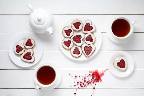 Shortbread heart shaped cookies for Valentines day with teapot and two cups of Stock Photos