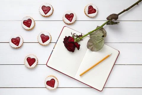 Shortbread homemade heart shaped cookies with empty notebook, pencil and rose Stock Photos