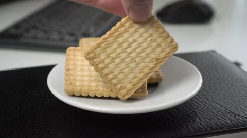 Shortbread snack on a leather notebook, computer equipment, keyboard and mous Stock Footage 160265968