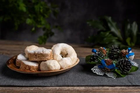 Shortbread, wine donuts and puff pastries next to a Christmas ornament, on .. Stock Photos
