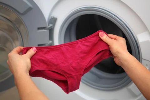 Shorts in hands for laundry Stock Photos