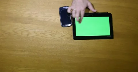 Shot from above and a person using tablet by searching through it - chroma key Vídeo Stock 49415123