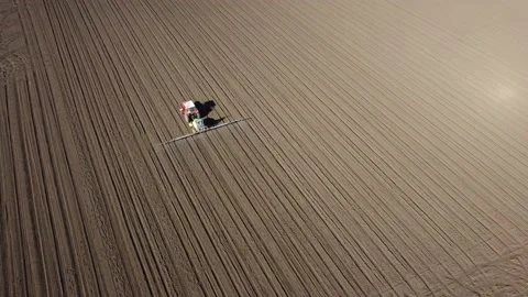 Shot from above - the tractor working on the plain Stock Footage 154637436
