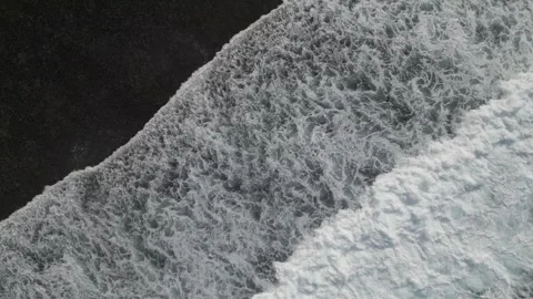 Shot from above of waves rolling onto the beach with snow-white foam, the waves Stock Footage 267957256