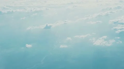 Shot of aerial view above clouds from airplane window with blue sky beautiful Video stock 138630916