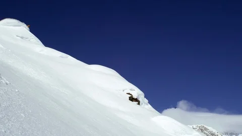 Shot from afar of skier sliding down a s, Stock Video