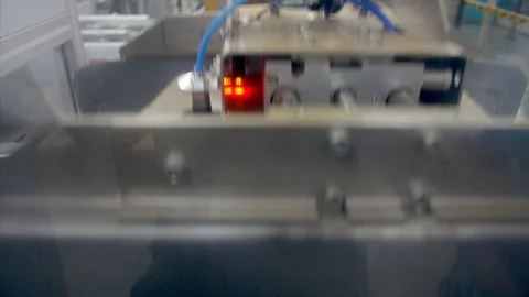 Shot of an automatic machine carrying packed thread spool Stock Footage 115404279