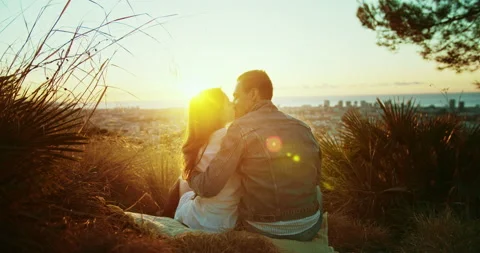 Shot from back of affectionate young couple with charming blur sunrise light Stock Footage 140737431