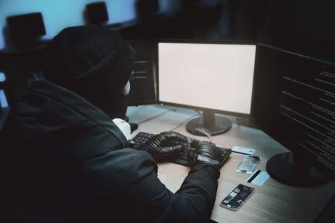 Shot from the Back to Hacker Breaking into Corporate Data Servers from His... Foto stock