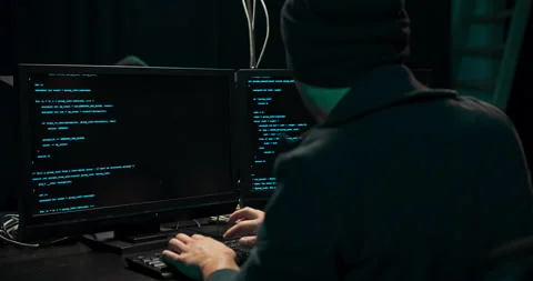 Shot from the Back to Hooded Hacker Breaking into Corporate Data Servers from Stock Footage 146100661