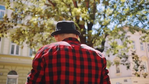 Shot on back man in hat walk in city center slow motion relax fashion model Stock Footage 92070802