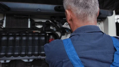 Shot back mechanic man with lamp working at workshop technician auto automobile Stock Footage 113917588