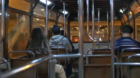 A shot from the back of passengers on a bus at night in Hong Kong China Stock Footage 144039783