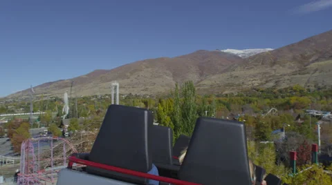 Shot from the back of a rollercoaster riding the track. Video stock 52263908