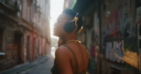 Shot back smiling young african american girl enjoying listening to music Stock Footage 160549752