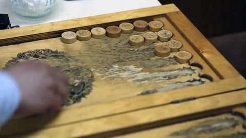 Shot of a backgammon play from above the board. Close up shot of two people play Stock Footage 75991884