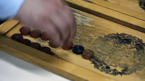 Shot of a backgammon play from above the board. Close up shot of two people play Stock Footage 75991914