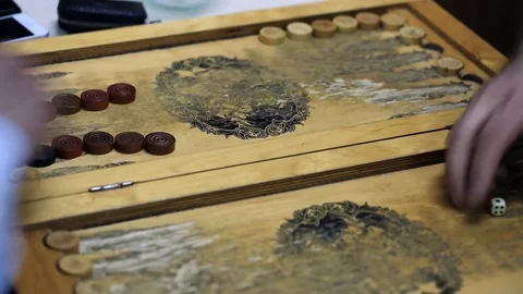 Shot of a backgammon play from above the board. Close up shot of two people play Stock Footage 75991924