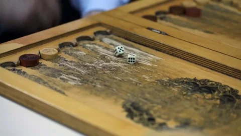 Shot of a backgammon play from above the board. Close up shot of two people play Stock Footage 75991931