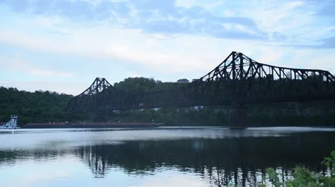 Shot of Barge Going Slow Under Train Bridge Stock Footage 58014078