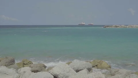 A shot of the beach at the bahamas with two cargo ships on the water 動画素材 112258805