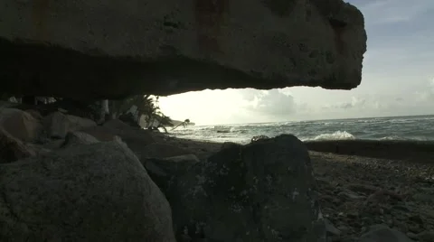 A shot of a beach through a rock formation Stock Footage 64221027
