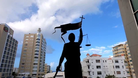 Shot Behind Lady Justice Statue in a Building Roof Stock Footage 129478611