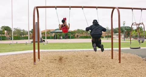 Shot from behind of two young boys at swings Stock Footage 242626935