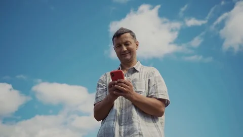 Shot from below man in the mountains use phone technology a concept of Stock Footage 116997865