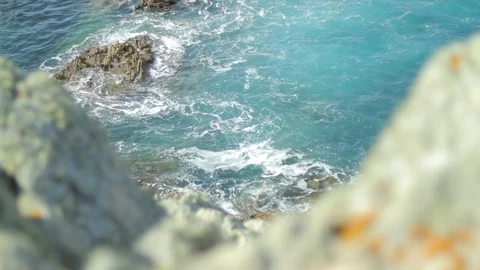 Shot between two rocks of coast line in bretagne with rocks in the ocean Stock Footage 86332794