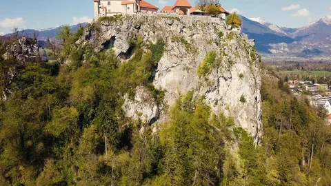 A shot of the Bled castle with a drone going up Stock Footage 106748420