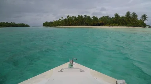A shot from the boat approaching 2 small tropical Carribean islands with palms. Stock Footage 201603549