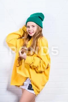 A shot of a bright emotional girl. Fashion for active kids. Stock Photos
