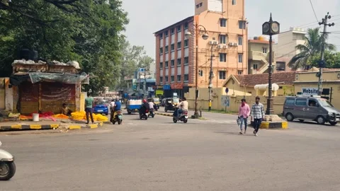 Shot of a bustling intersection in Mysore, India, with vehicles and pedestrians Stock Footage 306220406