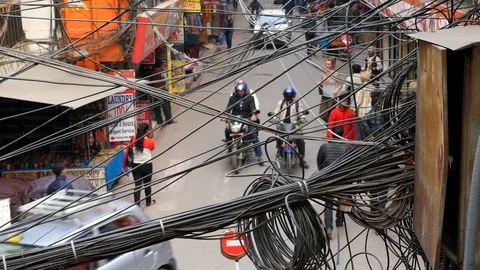 Shot of busy intersection in central Kathmandu Nepal electrical lines crossing Stock Footage 119349083