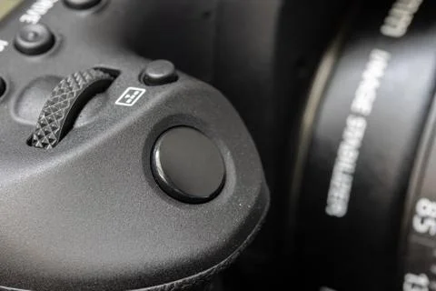 The shot button of a digital photo camera, close up. Photos