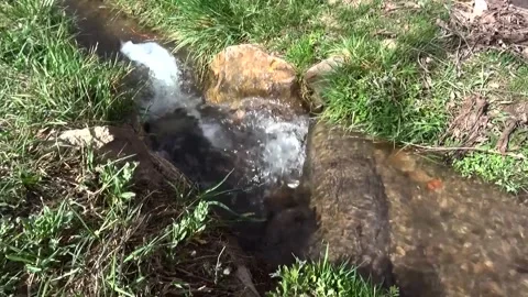 Shot captures a water stream entering the pathway, stock footage. Stock Footage 304865761