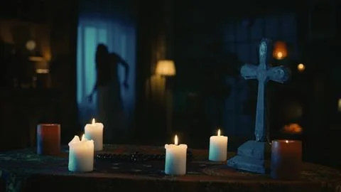 Shot capturing a table with magical tools on it: candles, cross and beads. On Foto stock