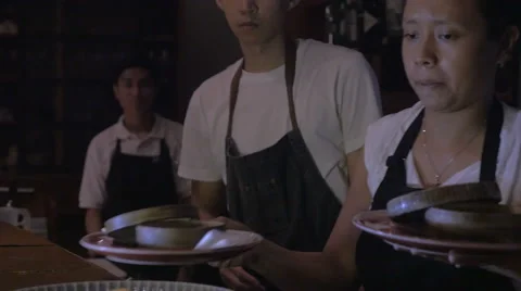A shot of chefs plating multiple desserts in a restaurant Stock Footage 58770472